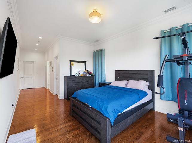 11 Island Point Bronx, NY 10464 - Photo 9 of 20 a bedroom with a bed and a flat screen television