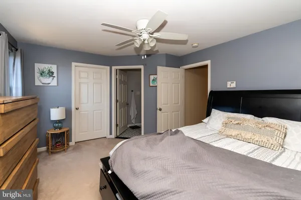 a bedroom with a bed and a bookshelf