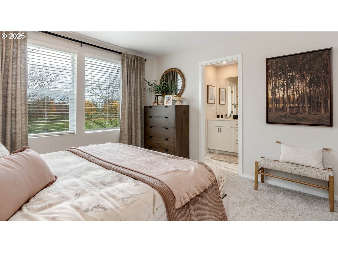 1095 Stubb Road Northeast Woodburn, OR 97071 - Photo 31 of 37 a bedroom with a bed and a painting on the wall