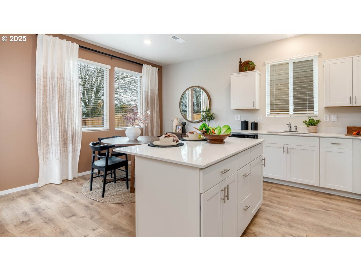 1095 Stubb Road Northeast Woodburn, OR 97071 - Photo 7 of 37 a kitchen with sink cabinets and window