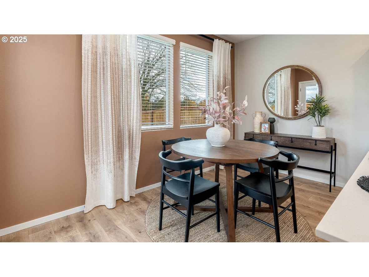 1095 Stubb Road Northeast Woodburn, OR 97071 - Photo 9 of 37 a kitchen with a dining table and chairs
