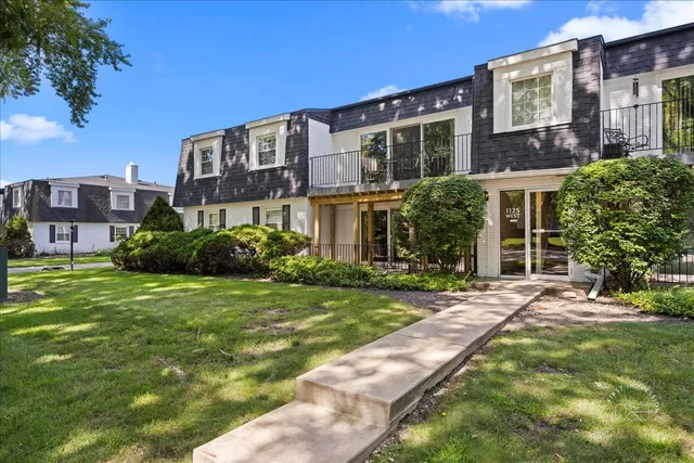 a front view of a building with a garden