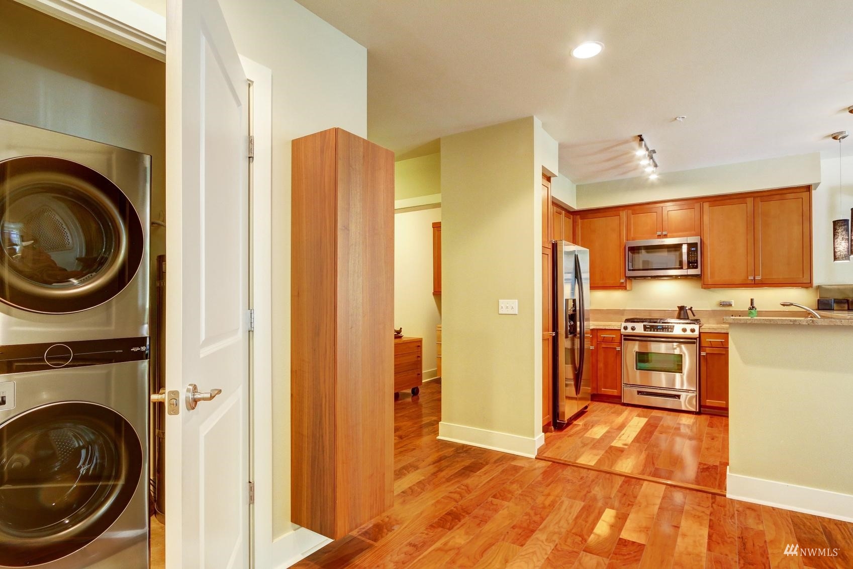 41 Pine Street, Unit 213 Edmonds, WA 98020 - Photo 12 of 25 a view of a kitchen with stainless steel appliances granite countertop a refrigerator and a stove top oven