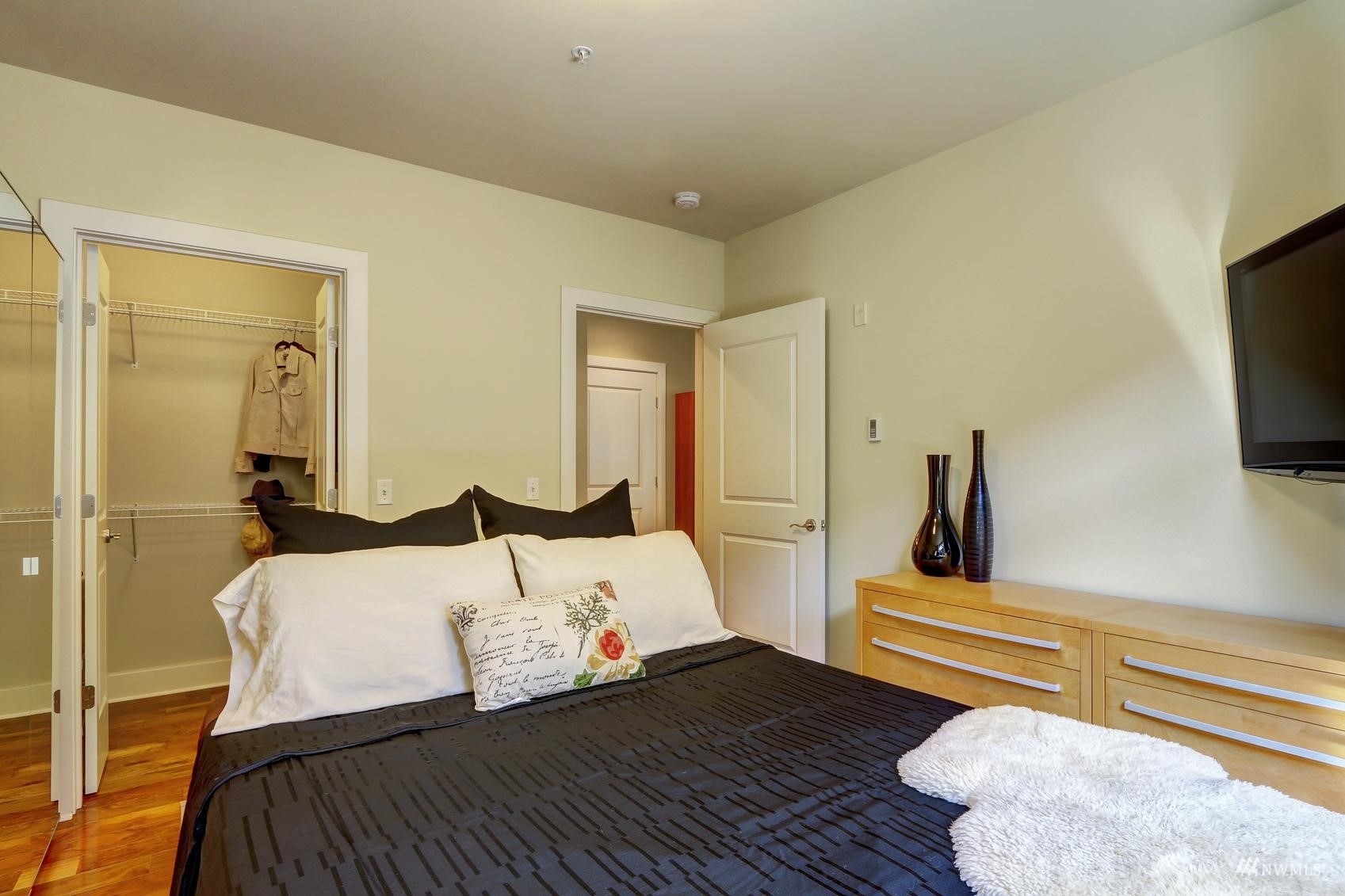 41 Pine Street, Unit 213 Edmonds, WA 98020 - Photo 15 of 25 a bedroom with a bed and flat screen tv