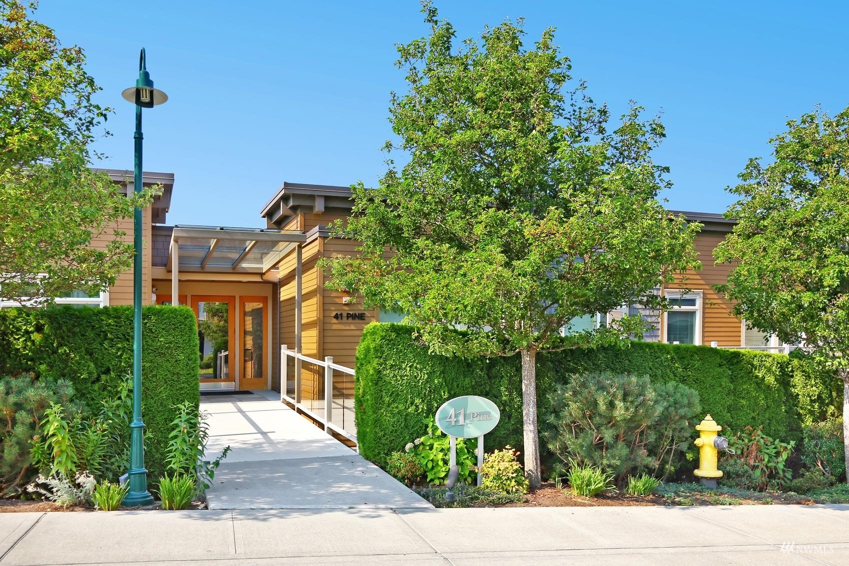 41 Pine Street, Unit 213 Edmonds, WA 98020 - Photo 3 of 25 front view of a house with a garden