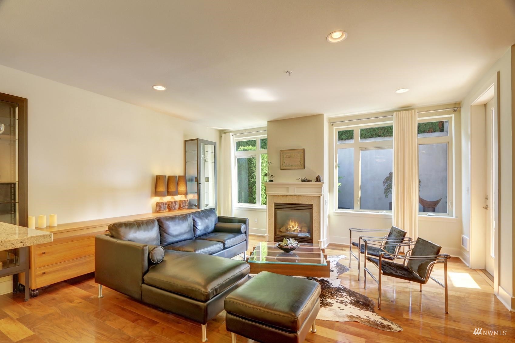 41 Pine Street, Unit 213 Edmonds, WA 98020 - Photo 6 of 25 a living room with furniture window and a fireplace