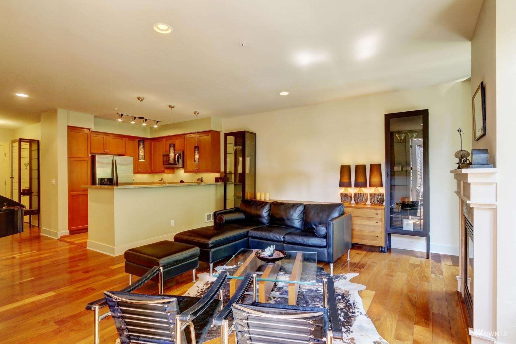 41 Pine Street, Unit 213 Edmonds, WA 98020 - Photo 8 of 25 a living room with furniture a flat screen tv and a table