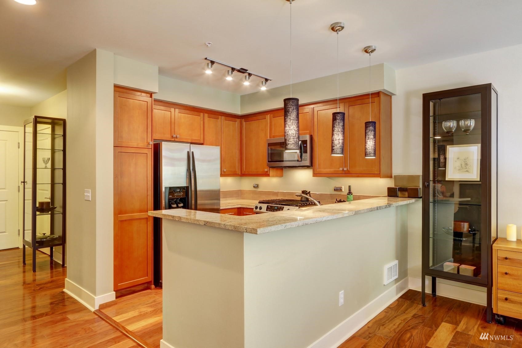 41 Pine Street, Unit 213 Edmonds, WA 98020 - Photo 9 of 25 a kitchen with stainless steel appliances a refrigerator and a stove