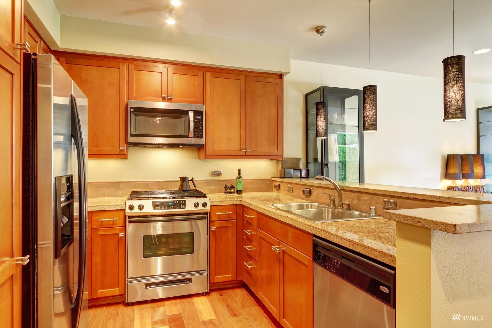 41 Pine Street, Unit 213 Edmonds, WA 98020 - Photo 10 of 25 a kitchen with stainless steel appliances granite countertop a sink stove and refrigerator