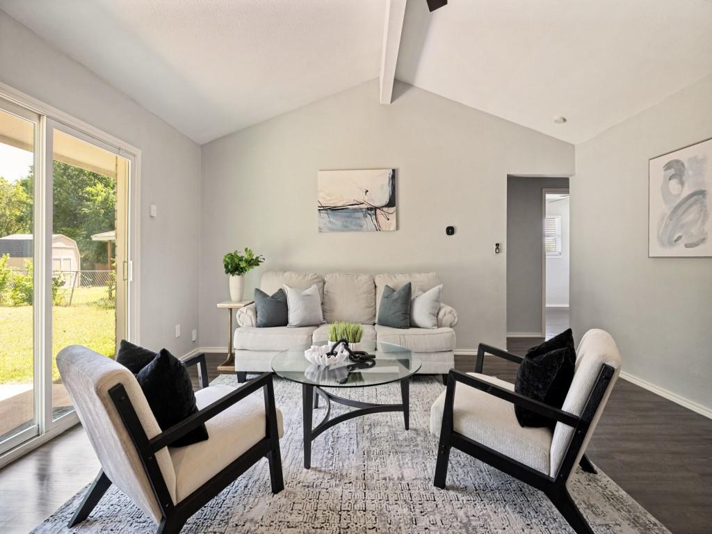 1405 Rambler Road Arlington, TX 76014 - Photo 7 of 26 Vaulted ceilings with exposed beam, sliding glass doors to the exterior, wood-finish flooring, and light gray wall tones