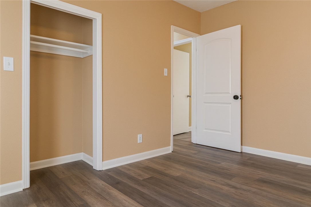 1122 Rickey Drive Corpus Christi, TX 78412 - Photo 6 of 8 a view of an empty room with wooden floor and closet