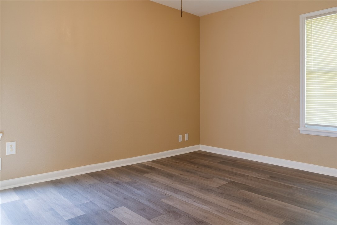 1122 Rickey Drive Corpus Christi, TX 78412 - Photo 7 of 8 a view of an empty room with wooden floor and a window