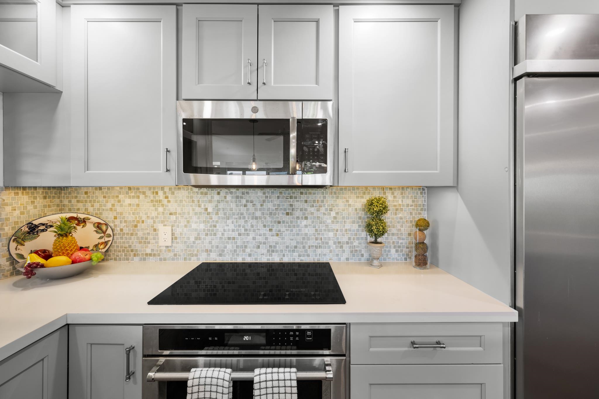 20 Hui Road East, Unit 35 Lahaina, HI 96761 - Photo 12 of 50 a kitchen with stainless steel appliances a stove a microwave and a refrigerator