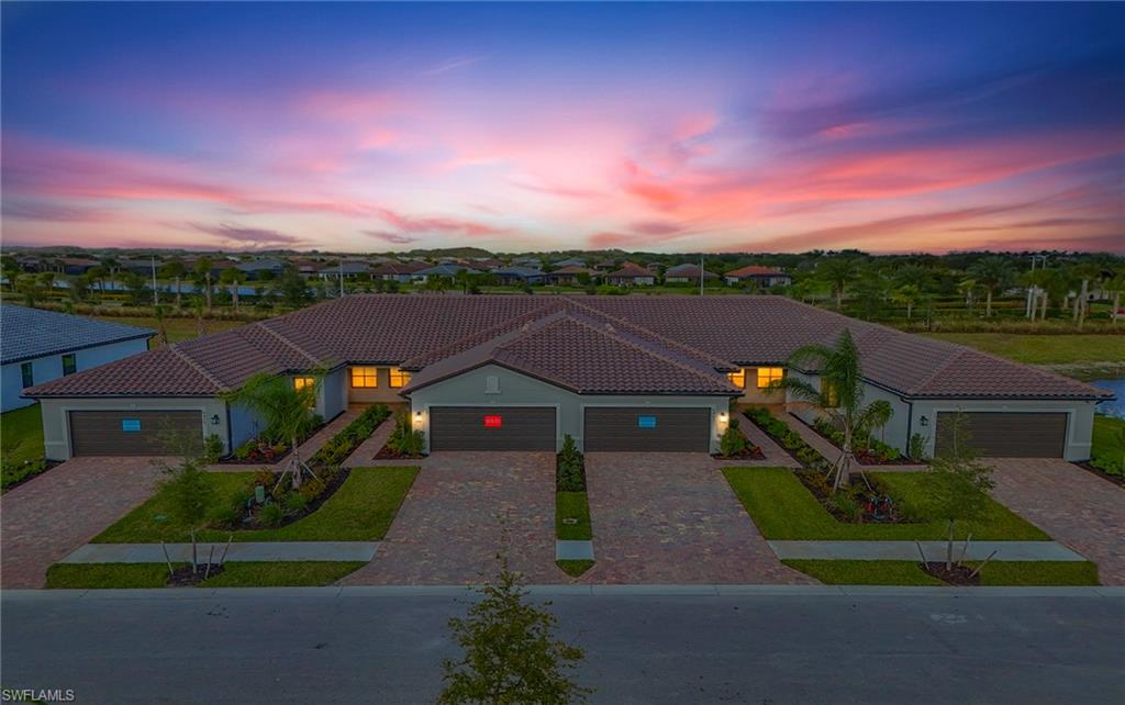 6407 Memorial Lane Ave Maria, FL 34142 - Photo 1 of 21 a front view of a house with a yard and garage
