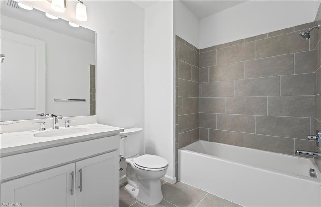 6407 Memorial Lane Ave Maria, FL 34142 - Photo 15 of 21 a bathroom with a sink a toilet and bathtub