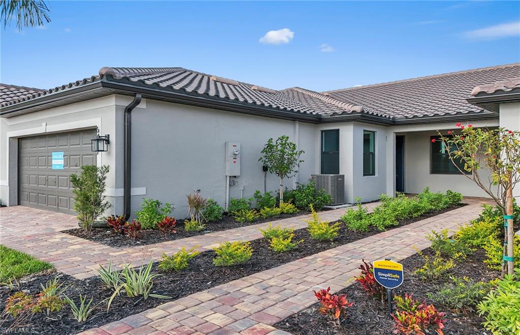 6407 Memorial Lane Ave Maria, FL 34142 - Photo 3 of 21 a front view of a house with a garden