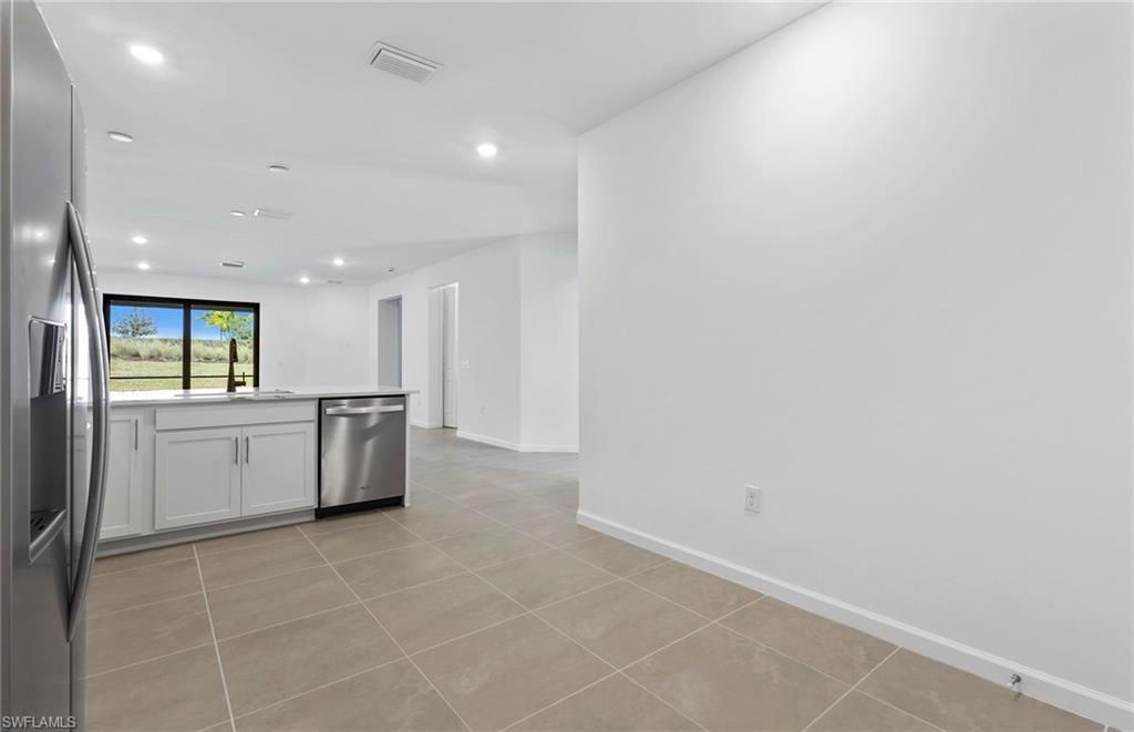 6407 Memorial Lane Ave Maria, FL 34142 - Photo 7 of 21 a large white kitchen with a sink and cabinets