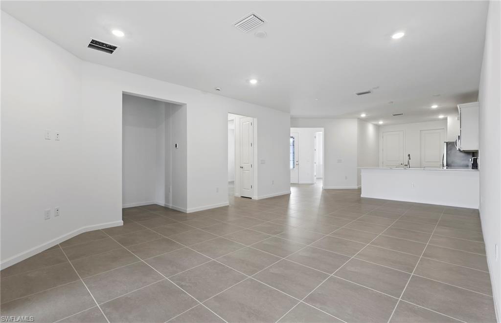 6407 Memorial Lane Ave Maria, FL 34142 - Photo 8 of 21 a view of an empty room with a kitchen