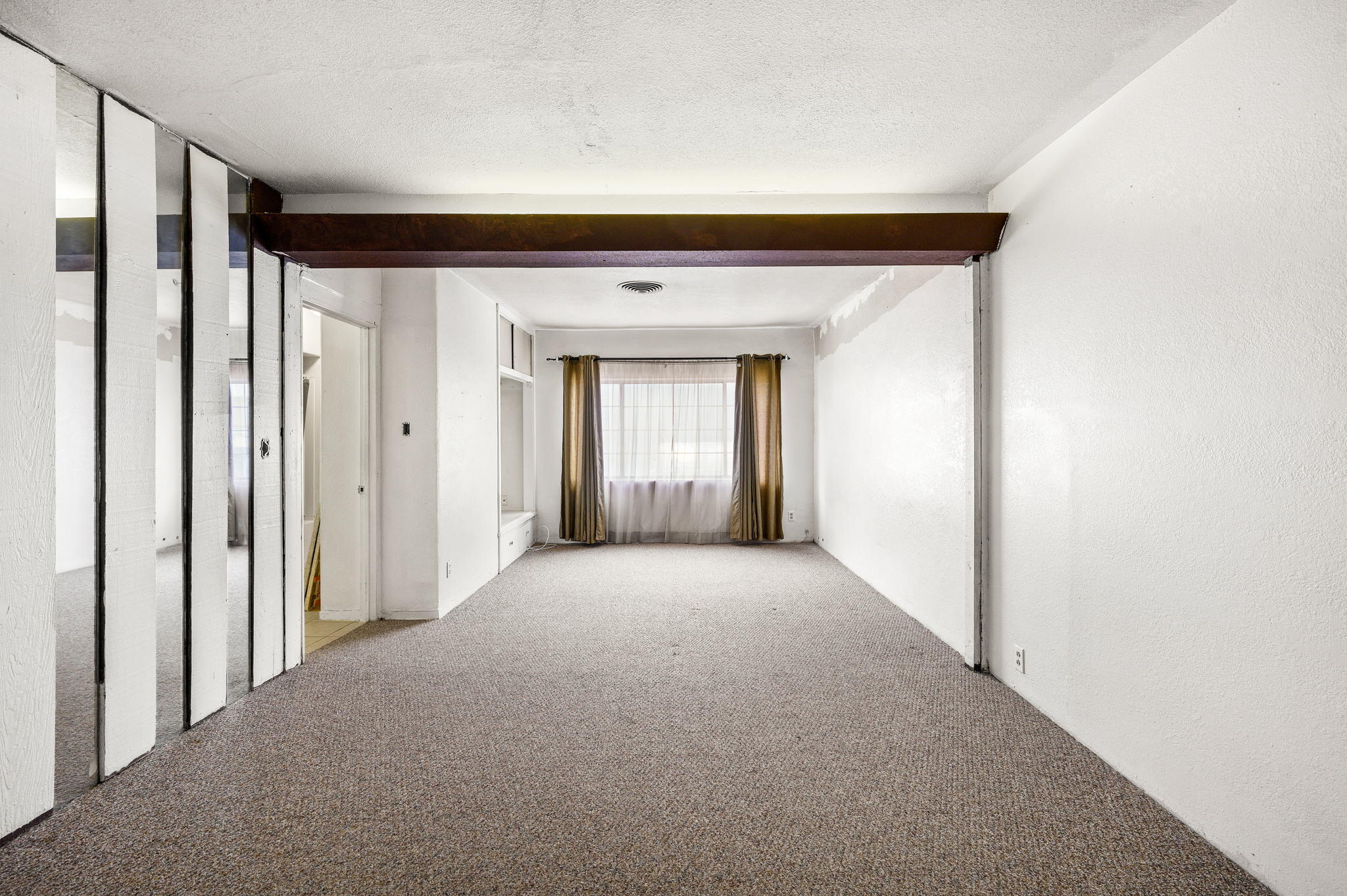 54521 Calhoun Street Thermal, CA 92274 - Photo 24 of 34 a view of a hallway with wooden floor and windows