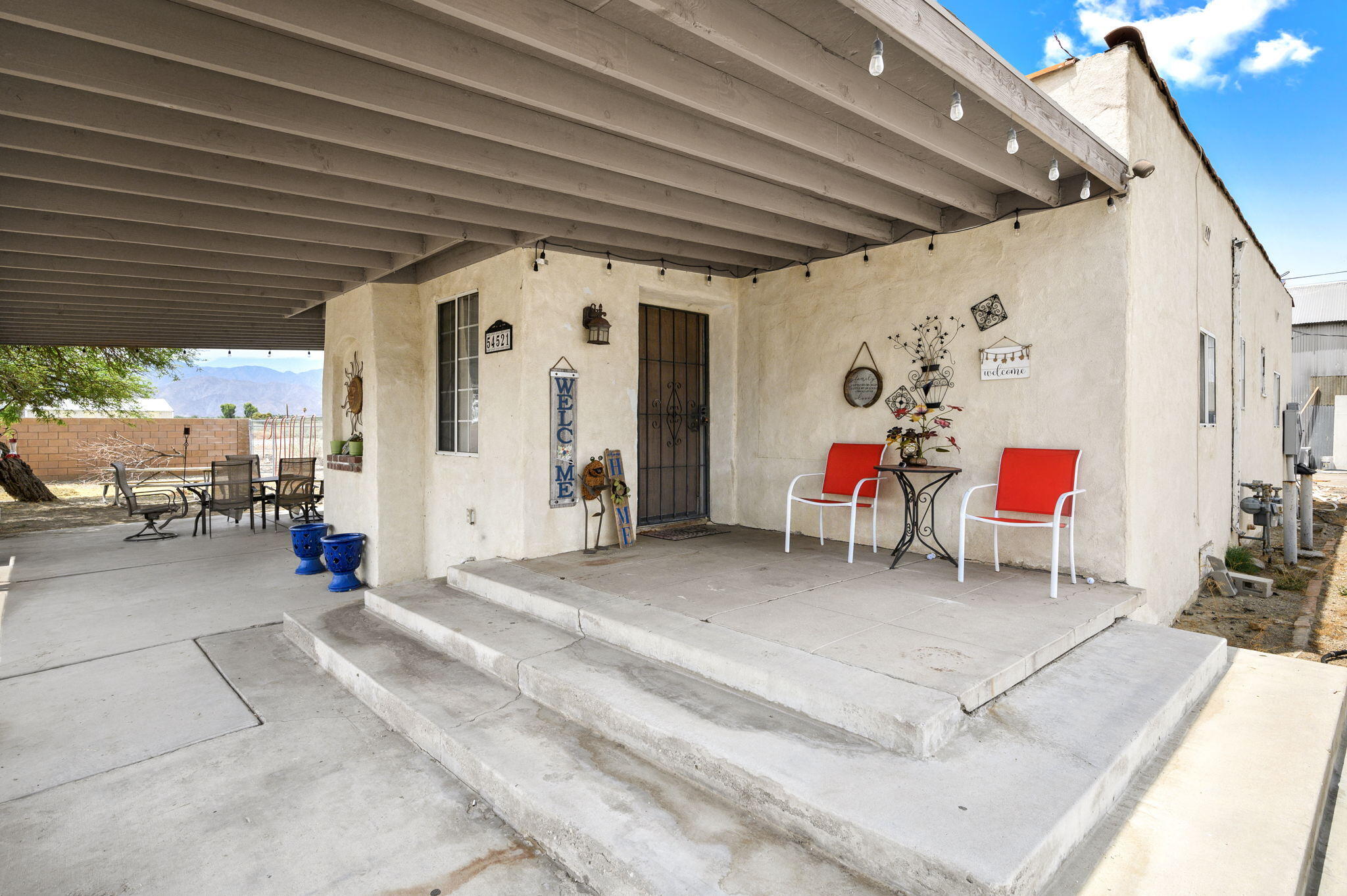 54521 Calhoun Street Thermal, CA 92274 - Photo 10 of 34 a living room with furniture and a chandelier