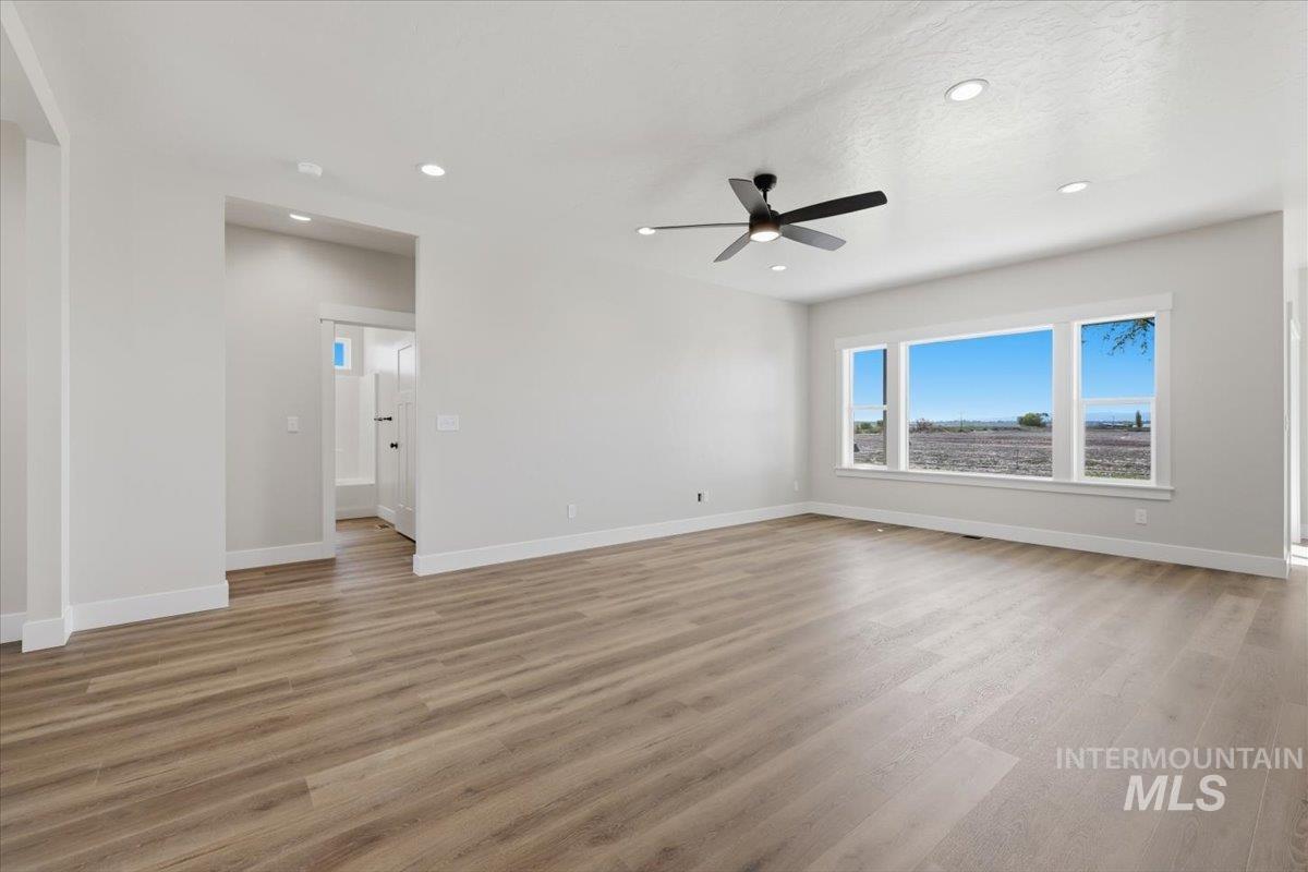 29343 Dixie Road Parma, ID 83660 - Photo 16 of 35 Unfurnished room featuring light wood finished floors, recessed lighting, and a ceiling fan