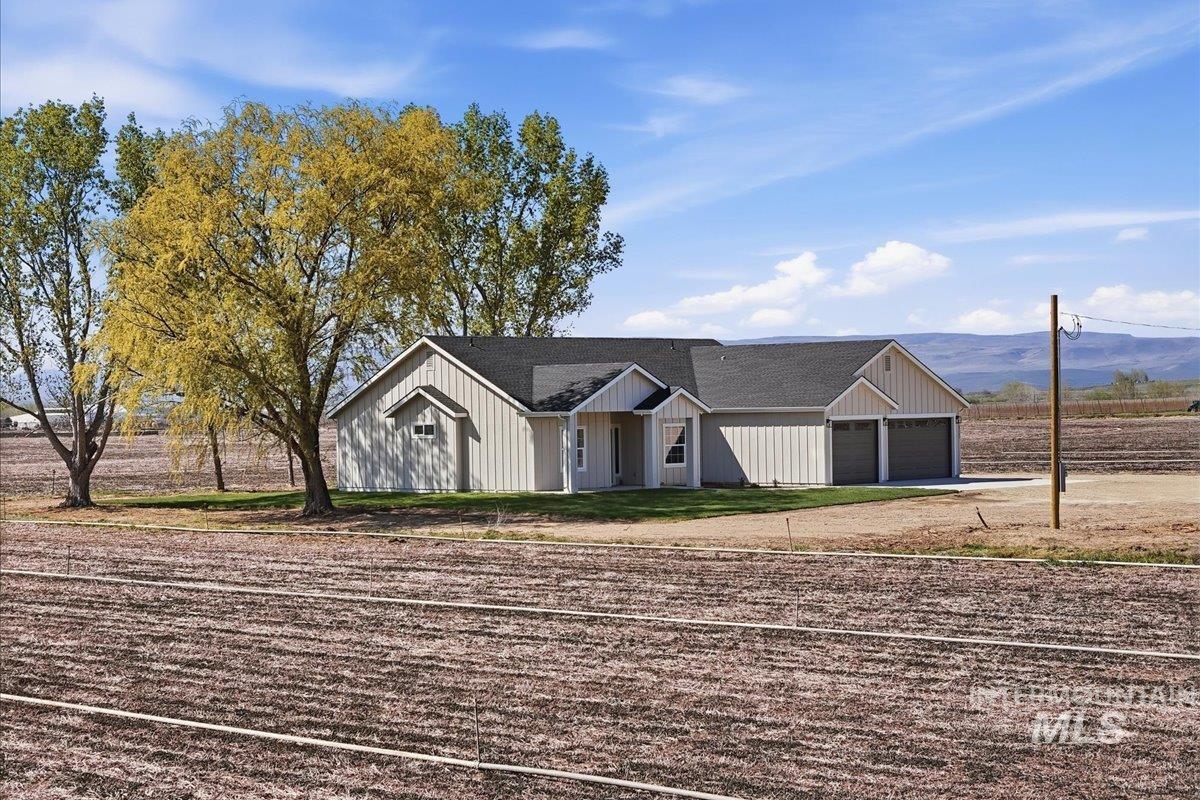 29343 Dixie Road Parma, ID 83660 - Photo 2 of 35 Modern inspired farmhouse featuring a shingled roof, an attached garage, driveway, and a mountain view