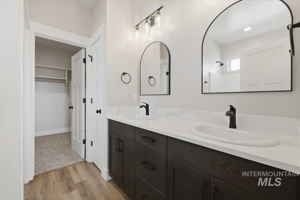 29343 Dixie Road Parma, ID 83660 - Photo 26 of 35 Bathroom with double vanity, light wood finished floors, and a spacious closet