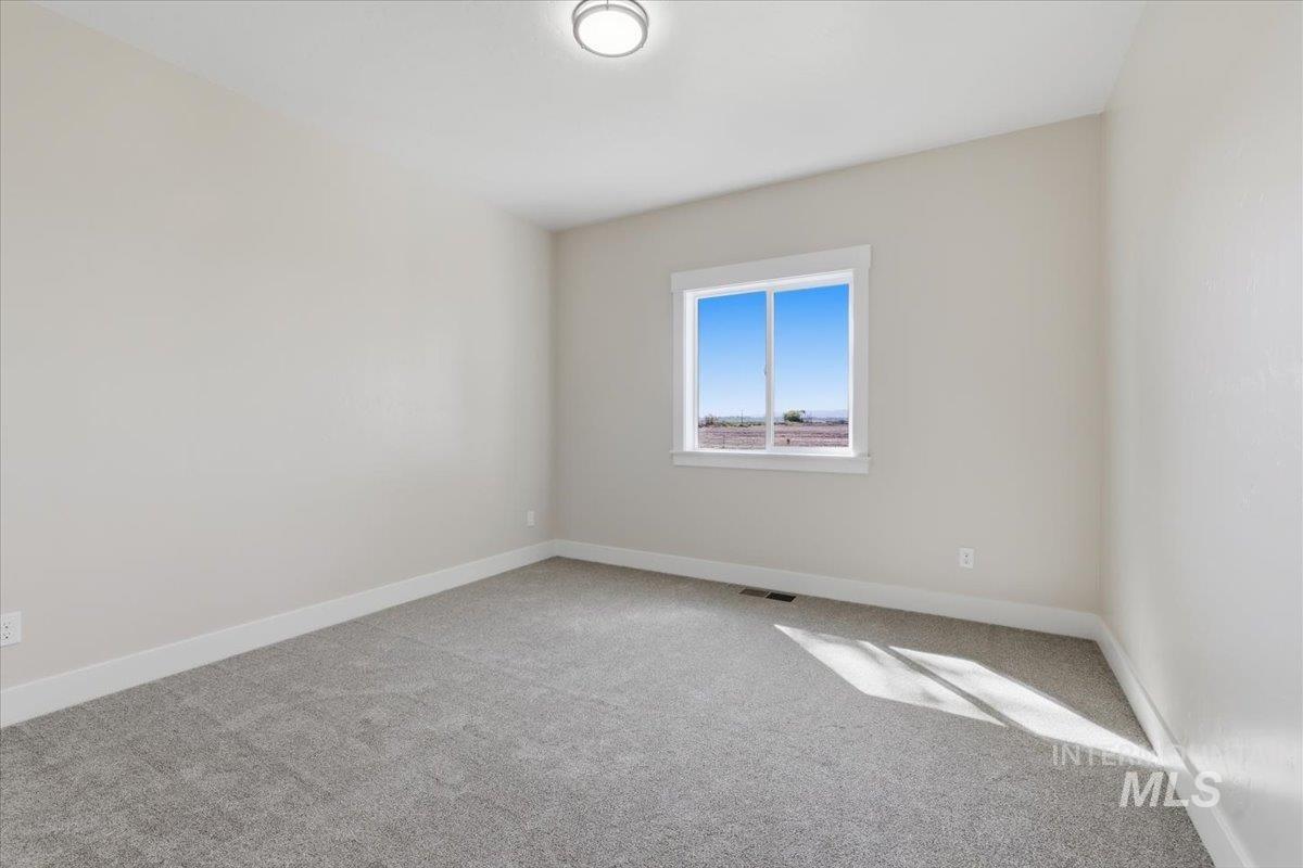 29343 Dixie Road Parma, ID 83660 - Photo 31 of 35 Empty room featuring carpet floors and baseboards