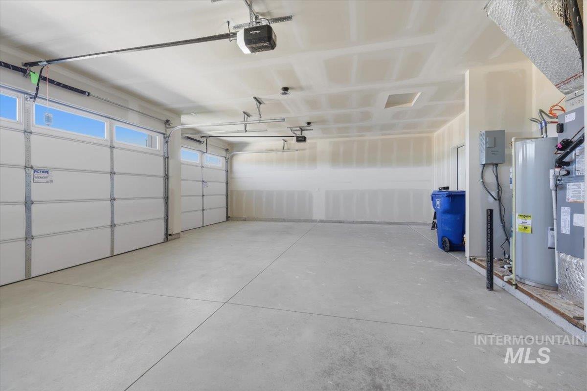 29343 Dixie Road Parma, ID 83660 - Photo 32 of 35 Garage featuring water heater and a garage door opener