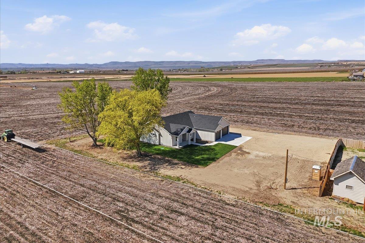29343 Dixie Road Parma, ID 83660 - Photo 5 of 35 Overview of rural landscape with rows of crops and a mountainous background