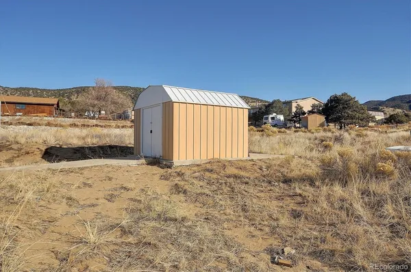 a view of a dirt road and building