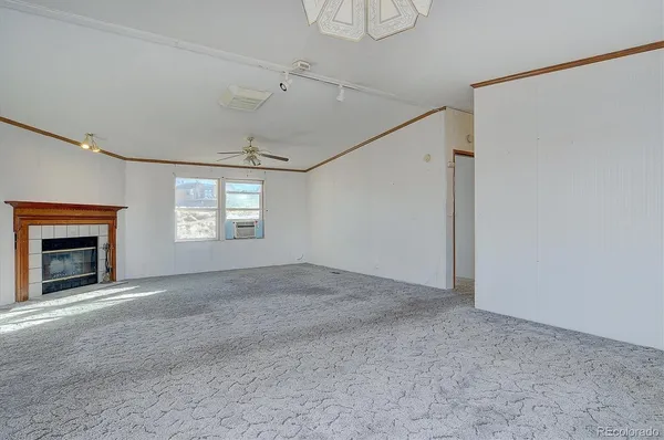 a view of empty room with a fireplace
