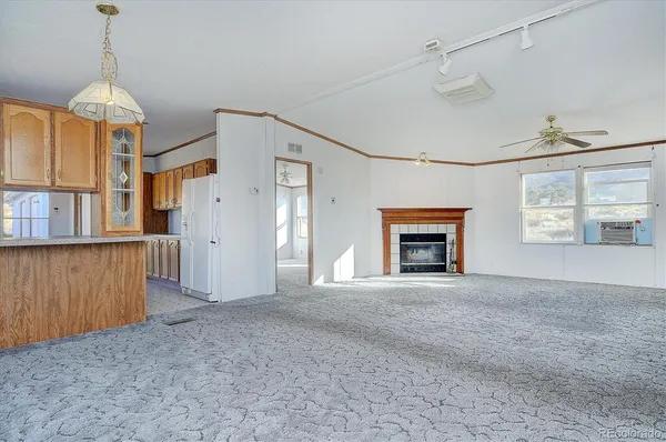 a view of an empty room with a fireplace and a window