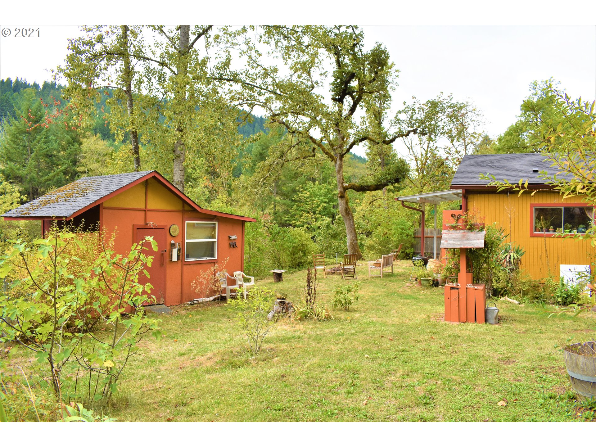37824 Row River Road Dorena, OR 97434 - Photo 17 of 25 a backyard of a house with table and chairs