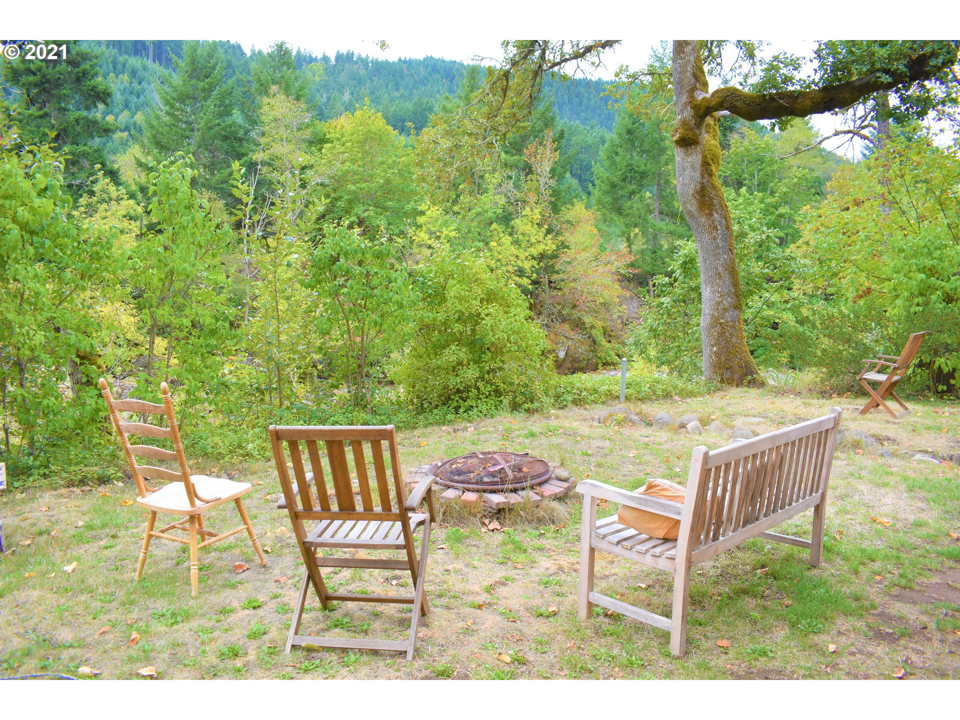 37824 Row River Road Dorena, OR 97434 - Photo 18 of 25 a backyard of a house with table and chairs
