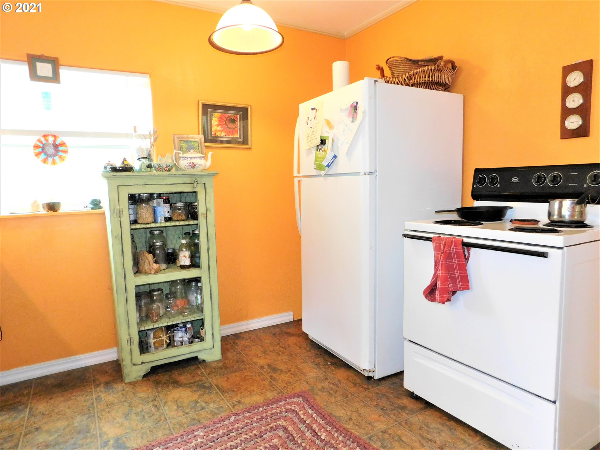 37824 Row River Road Dorena, OR 97434 - Photo 8 of 25 a room with a refrigerator and a stove