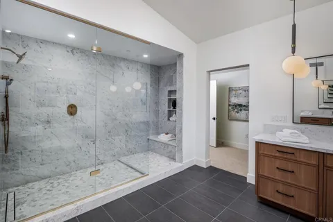 a bathroom with a shower sink and mirror