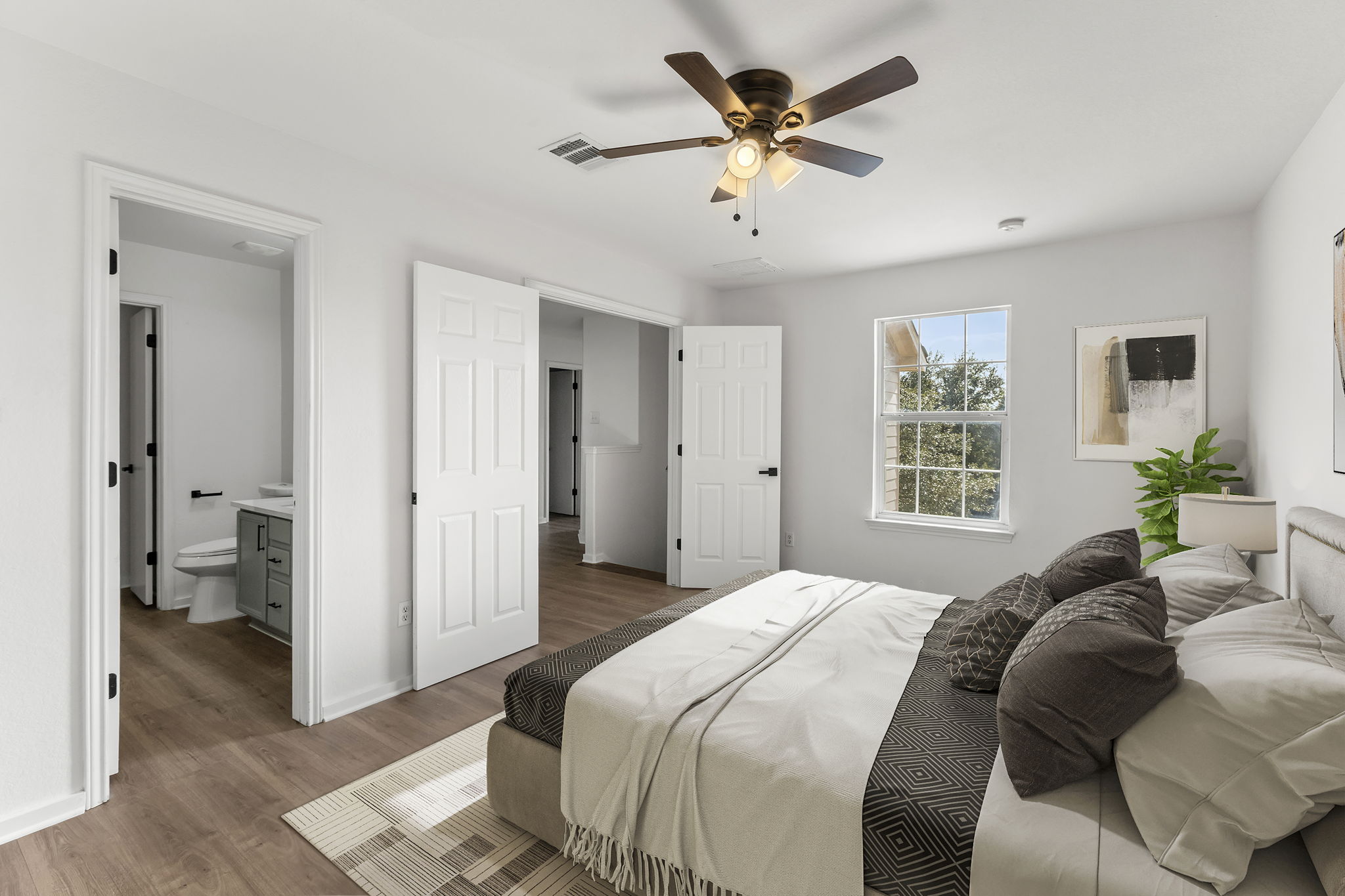 2110 Nogales Trail Austin, TX 78744 - Photo 19 of 37 a bedroom with a large bed and a chandelier
