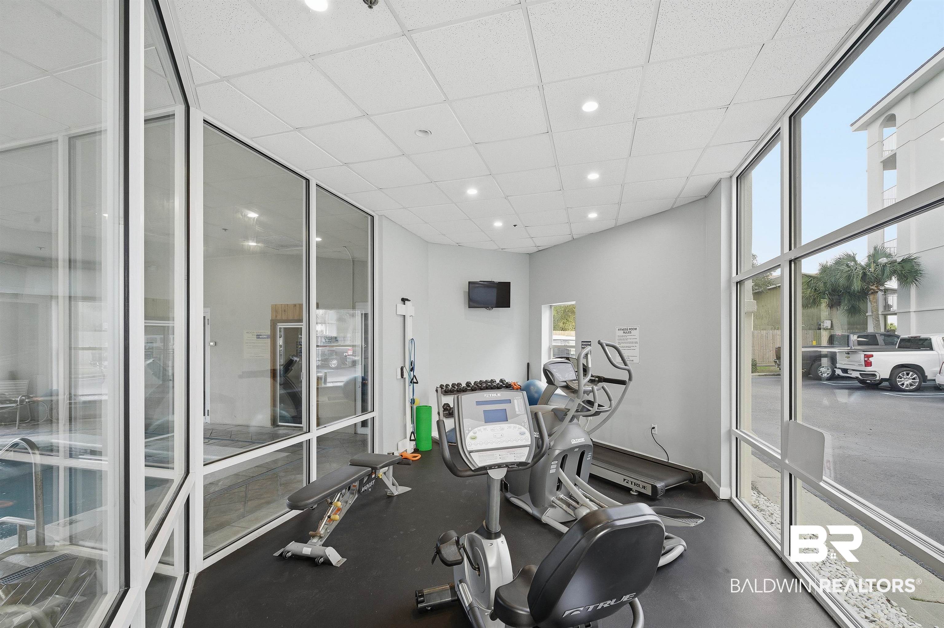 27282 Canal Road, Unit 408 Orange Beach, AL 36561 - Photo 30 of 37 Workout area featuring a drop ceiling, recessed lighting, and floor to ceiling windows