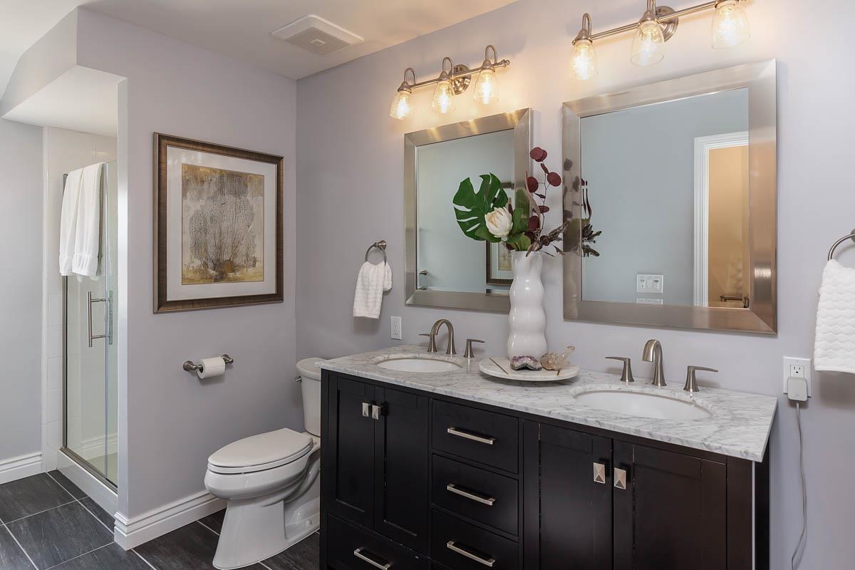 822 Springer Road Los Altos, CA 94024 - Photo 12 of 25 a bathroom with a granite countertop toilet sink and mirror