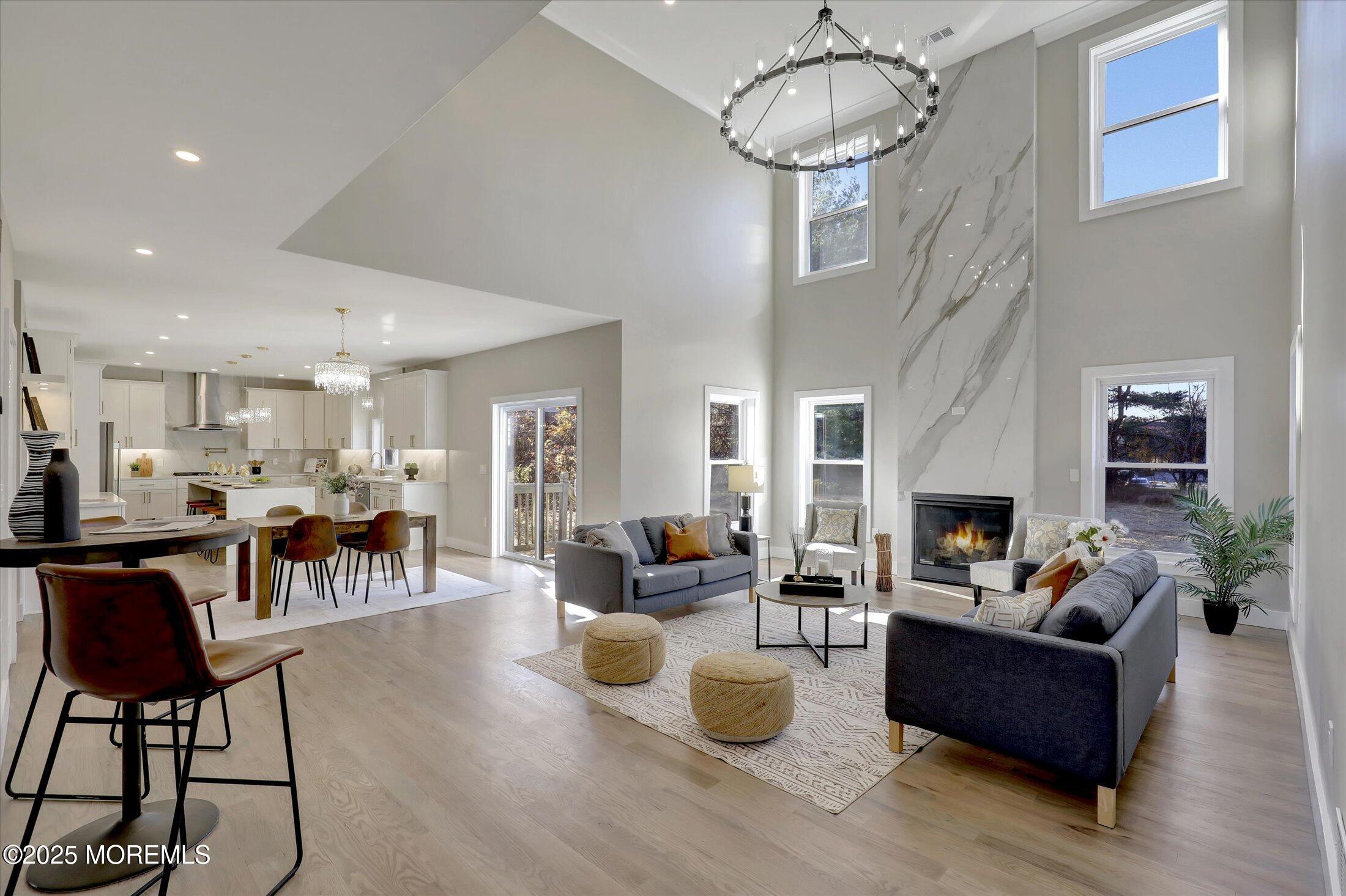750 Holmdel Road Holmdel, NJ 07733 - Photo 14 of 55 a living room with furniture a dining table and a chandelier