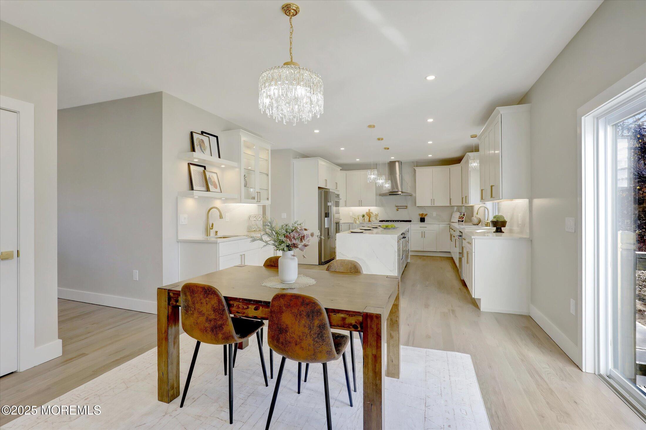 750 Holmdel Road Holmdel, NJ 07733 - Photo 18 of 55 a view of a dining room and livingroom with furniture wooden floor a rug a chandelier