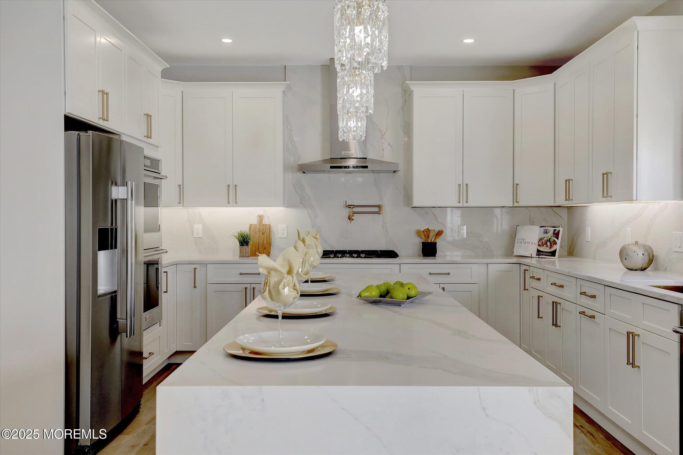 750 Holmdel Road Holmdel, NJ 07733 - Photo 22 of 55 a kitchen with stainless steel appliances a white refrigerator a sink a stove and white cabinets