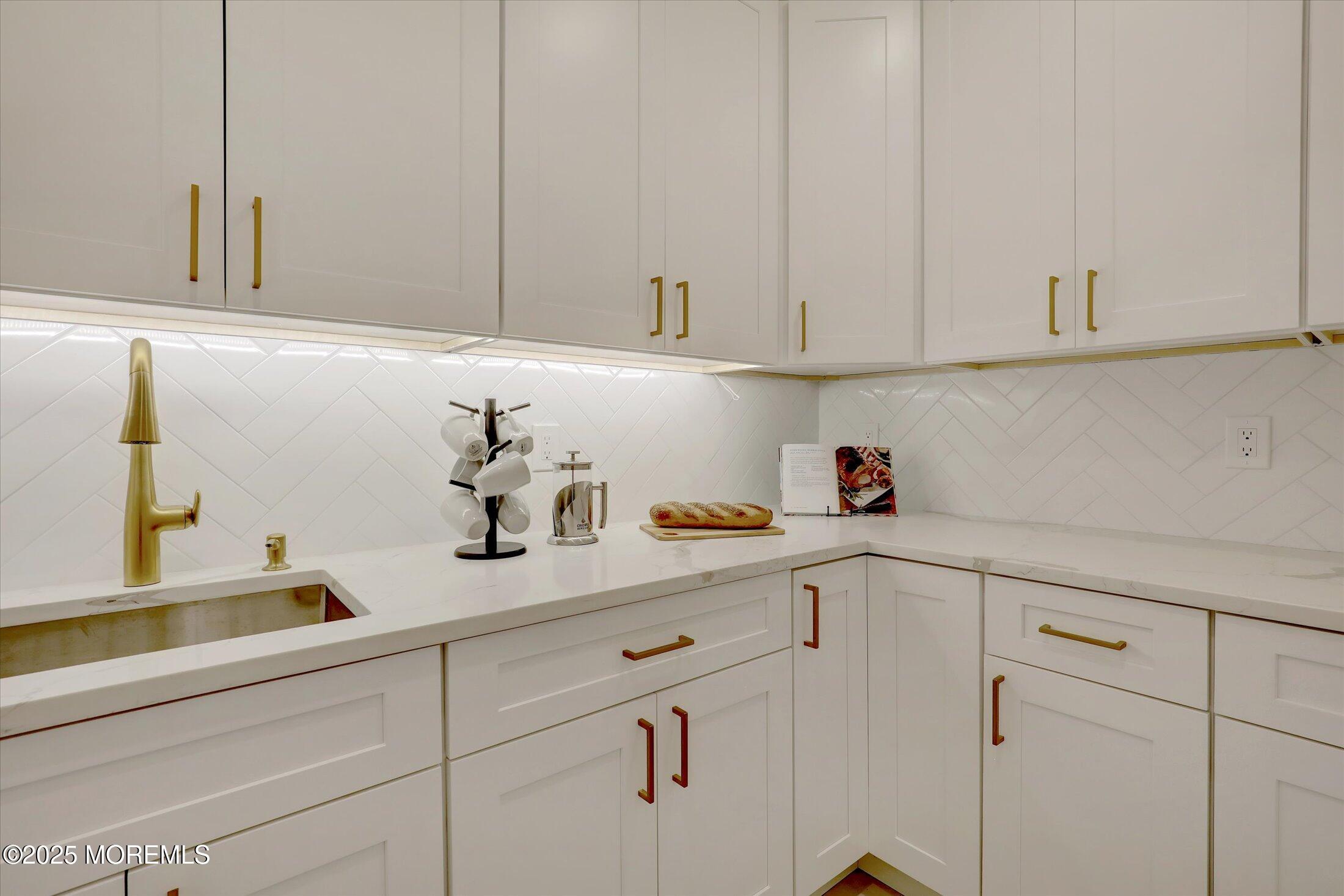 750 Holmdel Road Holmdel, NJ 07733 - Photo 23 of 55 a kitchen with white cabinets and a sink
