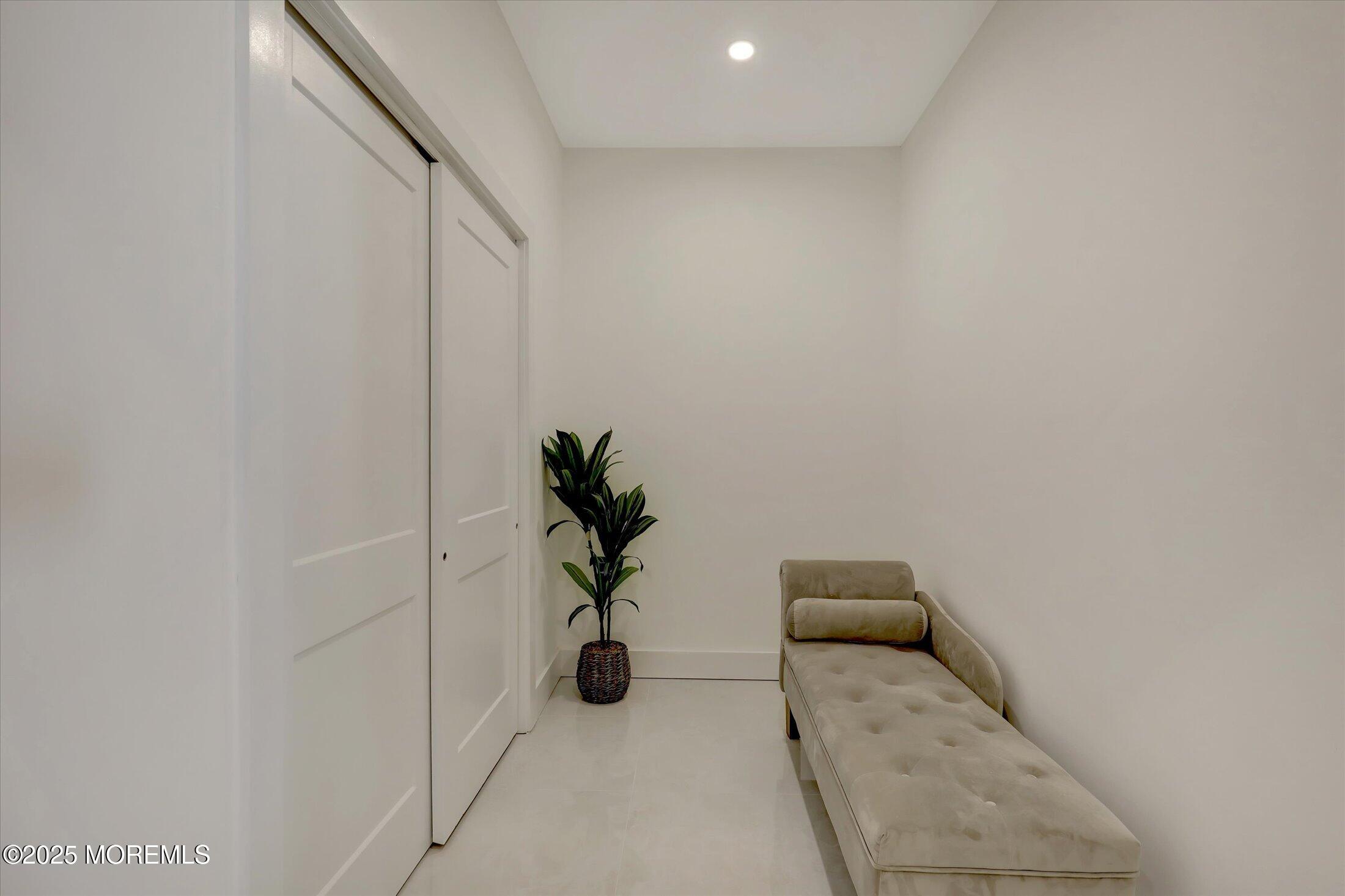 750 Holmdel Road Holmdel, NJ 07733 - Photo 24 of 55 a hallway with a potted plant on a rug