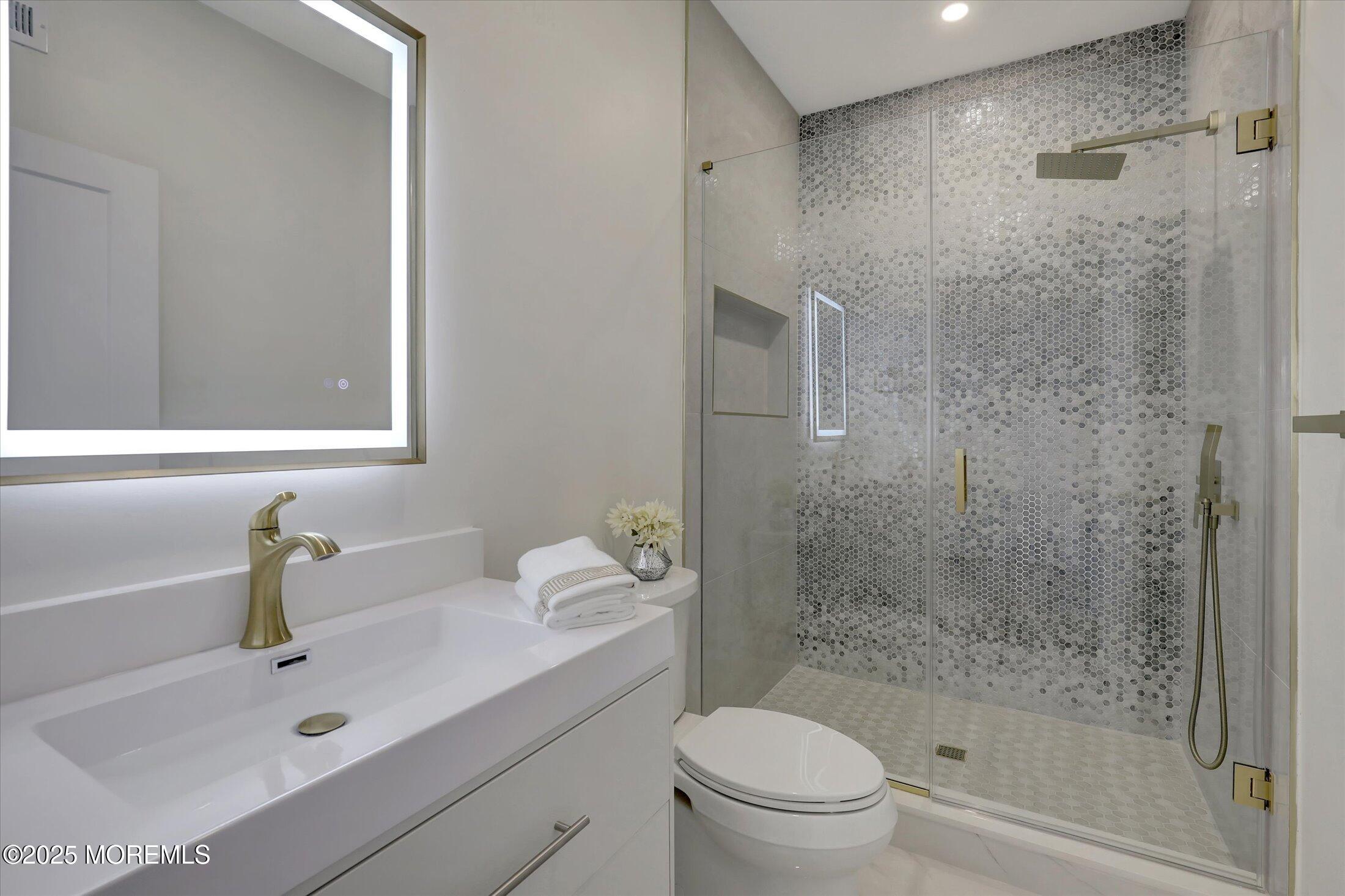 750 Holmdel Road Holmdel, NJ 07733 - Photo 25 of 55 a bathroom with a sink mirror toilet and shower