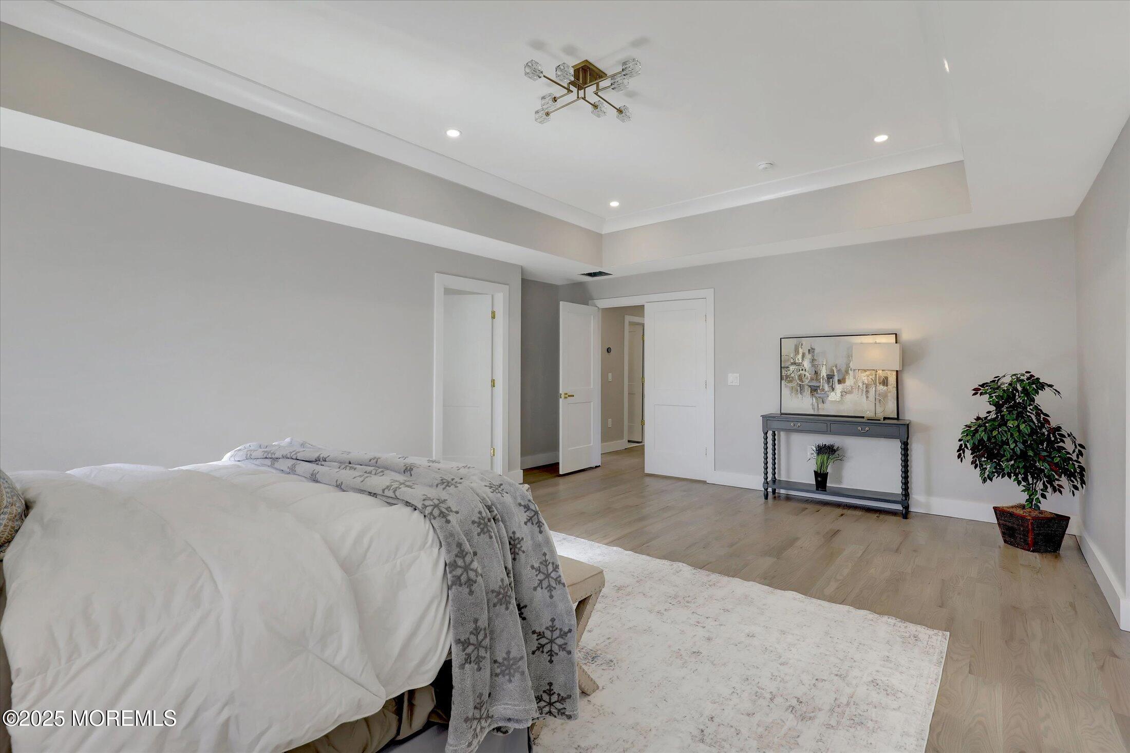 750 Holmdel Road Holmdel, NJ 07733 - Photo 30 of 55 a spacious bedroom with a bed and a potted plant