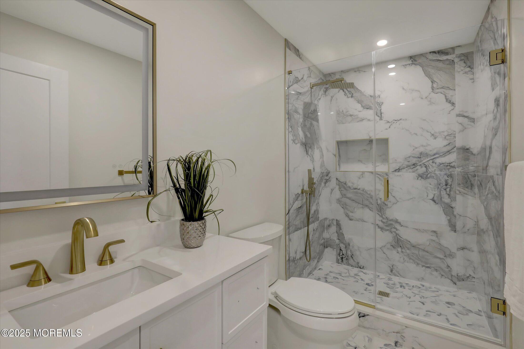 750 Holmdel Road Holmdel, NJ 07733 - Photo 39 of 55 a bathroom with a granite countertop sink a toilet and shower