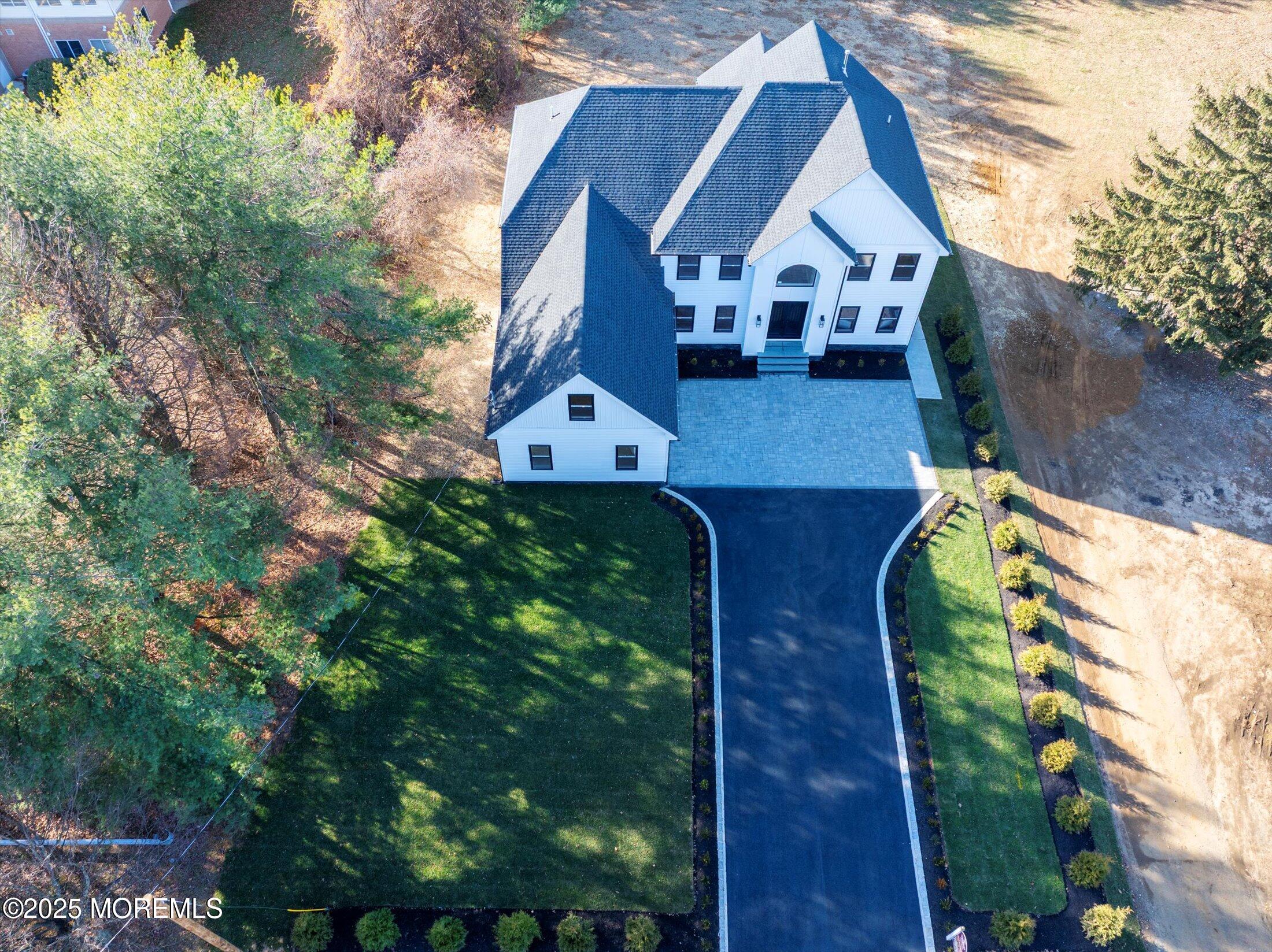 750 Holmdel Road Holmdel, NJ 07733 - Photo 52 of 55 a view of house with a yard and potted plants