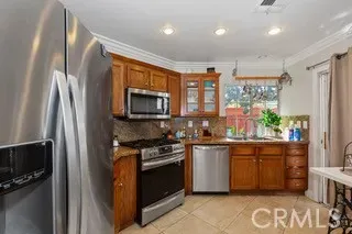 a kitchen with stainless steel appliances granite countertop a stove a sink and a refrigerator